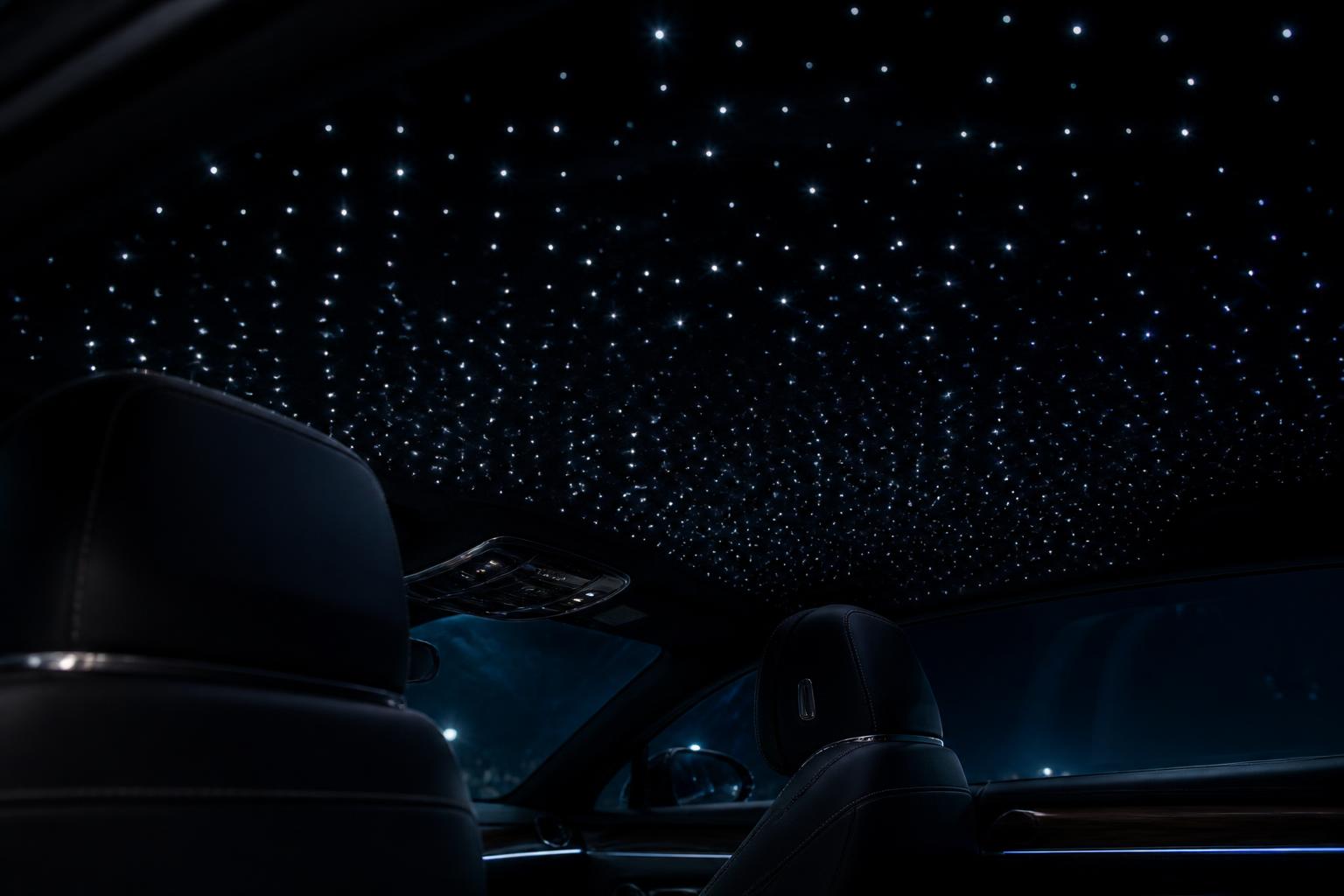 Fiber-optic starlight headliner installed in a car roof at night